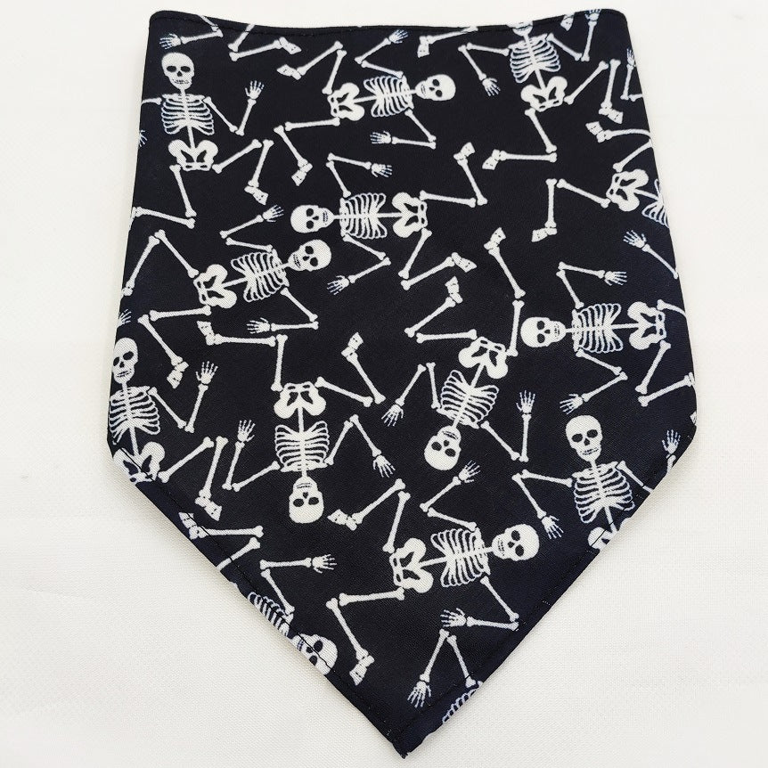Black fabric bandana with white skeleton pattern, Halloween-themed pet accessory