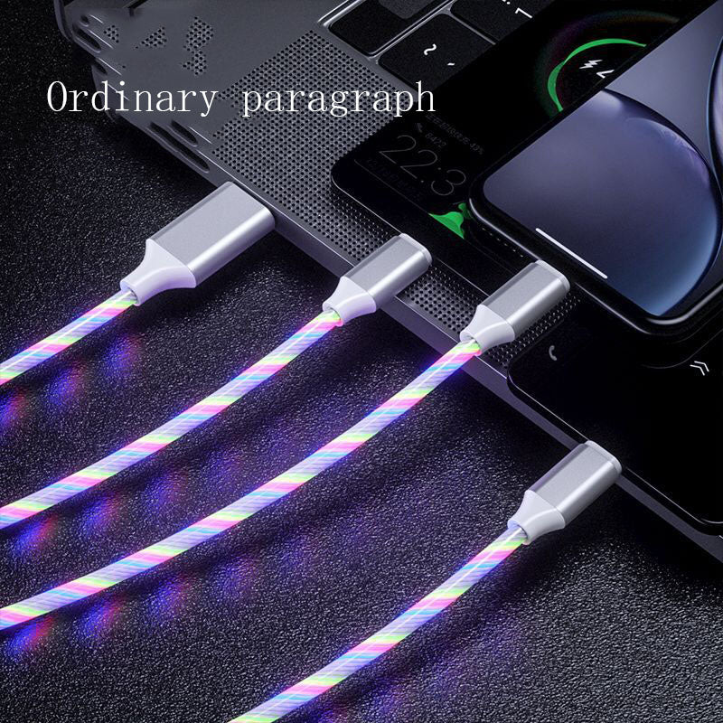 3-in-1 LED glowing charging cables with USB-C, Micro USB, and iPhone connectors plugged into laptop and phones