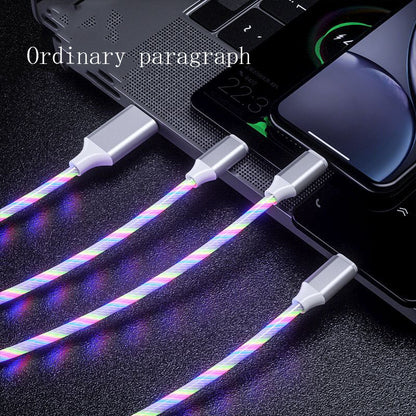 3-in-1 LED glowing charging cables with USB-C, Micro USB, and iPhone connectors plugged into laptop and phones