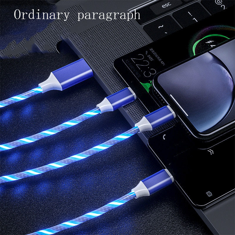 3-in-1 LED glowing charging cables connected to smartphone and laptop ports, blue light effect