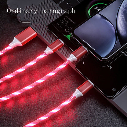 Red LED glowing 3-in-1 USB charging cables connected to multiple smartphones on a laptop