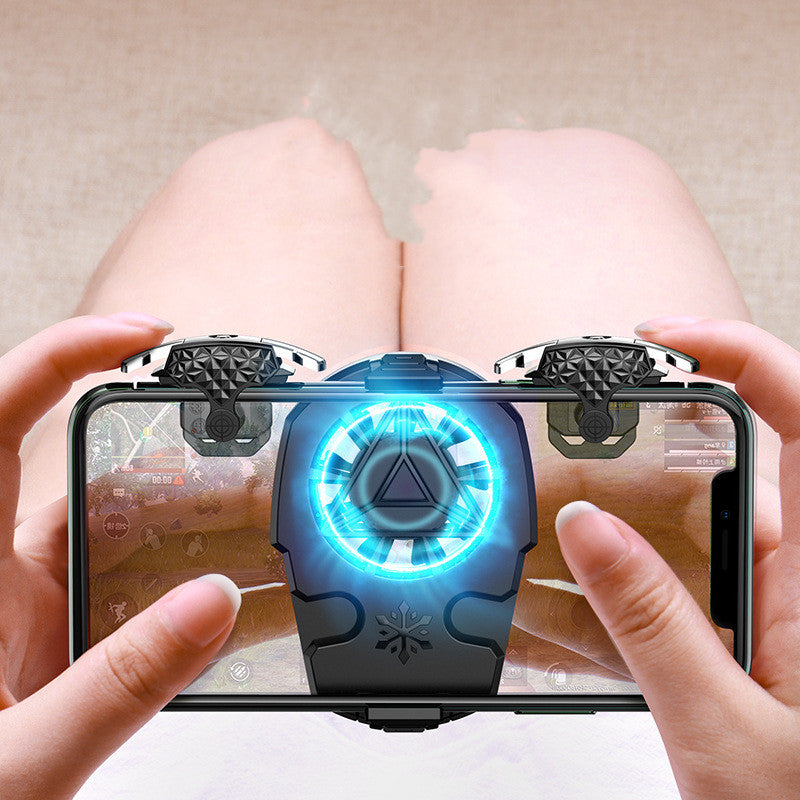 Hands holding smartphone with black cooling fan and triggers for mobile gaming