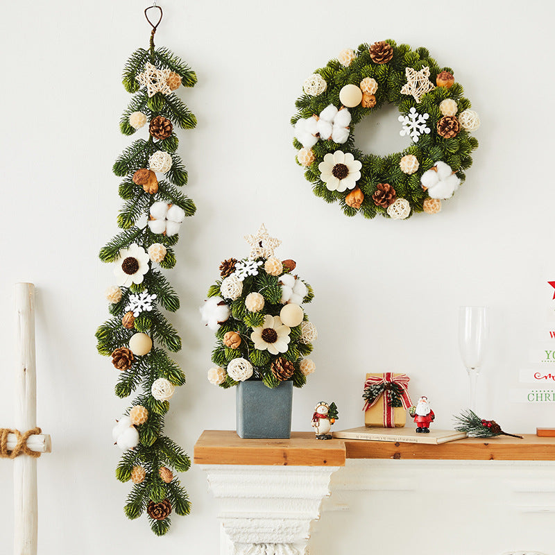 Festive Christmas wreath, garland, and tabletop decoration with pinecones, cotton, and white ornaments