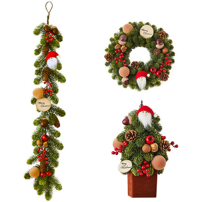 Festive Christmas decorations including a wreath, garland, and tabletop tree with Santa, pinecones, berries