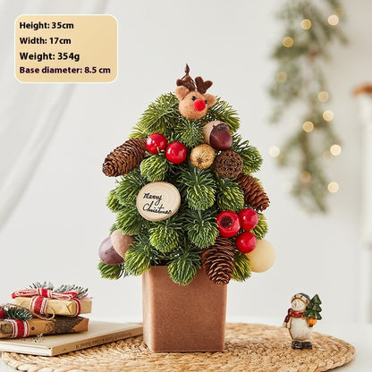 Mini Christmas tree decoration with pine cones, red berries, reindeer ornament, and wooden Merry Christmas sign in a brown pot
