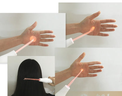 Red high frequency skin therapy wand used on hand and hair for acne and scalp treatment