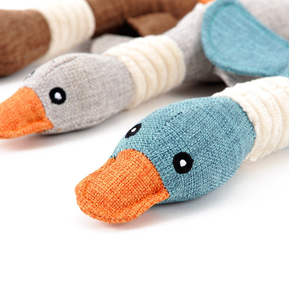 Durable plush duck dog toy in blue and beige with orange beak for interactive pet playtime