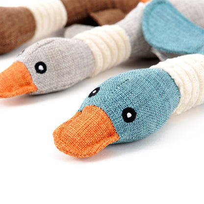 Durable plush duck dog toy in blue and beige with orange beak for interactive pet playtime