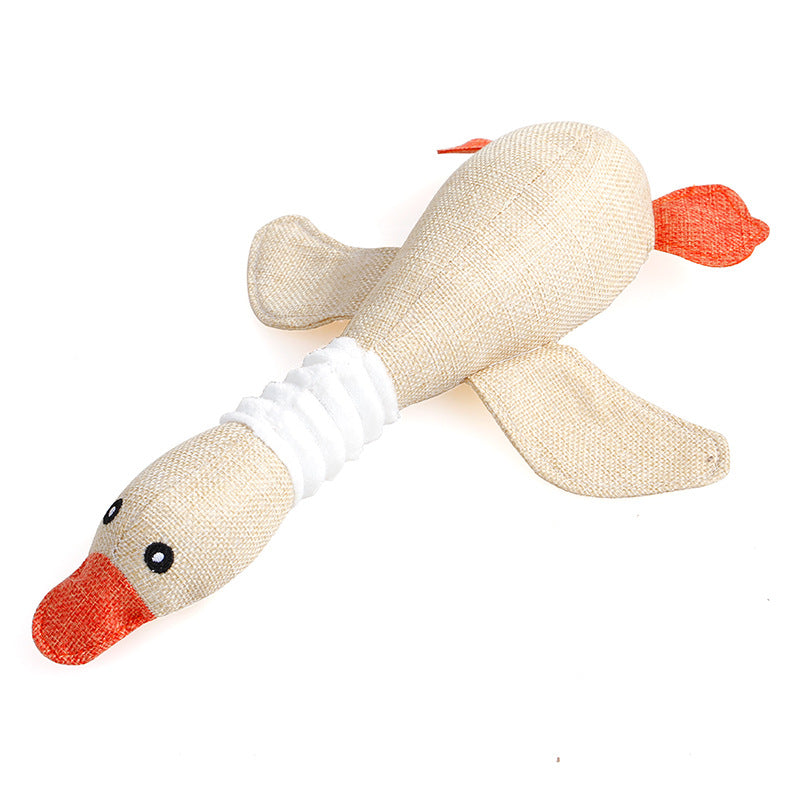 Beige plush duck dog toy with orange beak and tail, durable squeaky interactive pet play