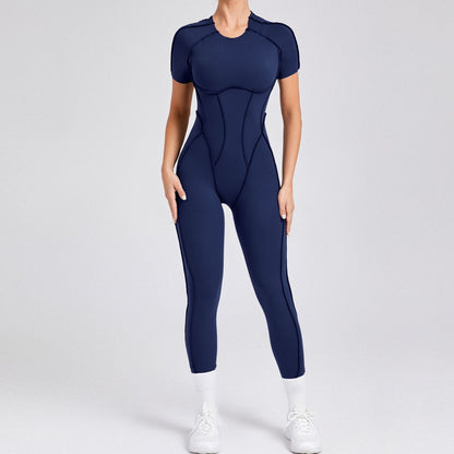 Woman wearing navy blue fitted athletic jumpsuit with short sleeves and white sneakers