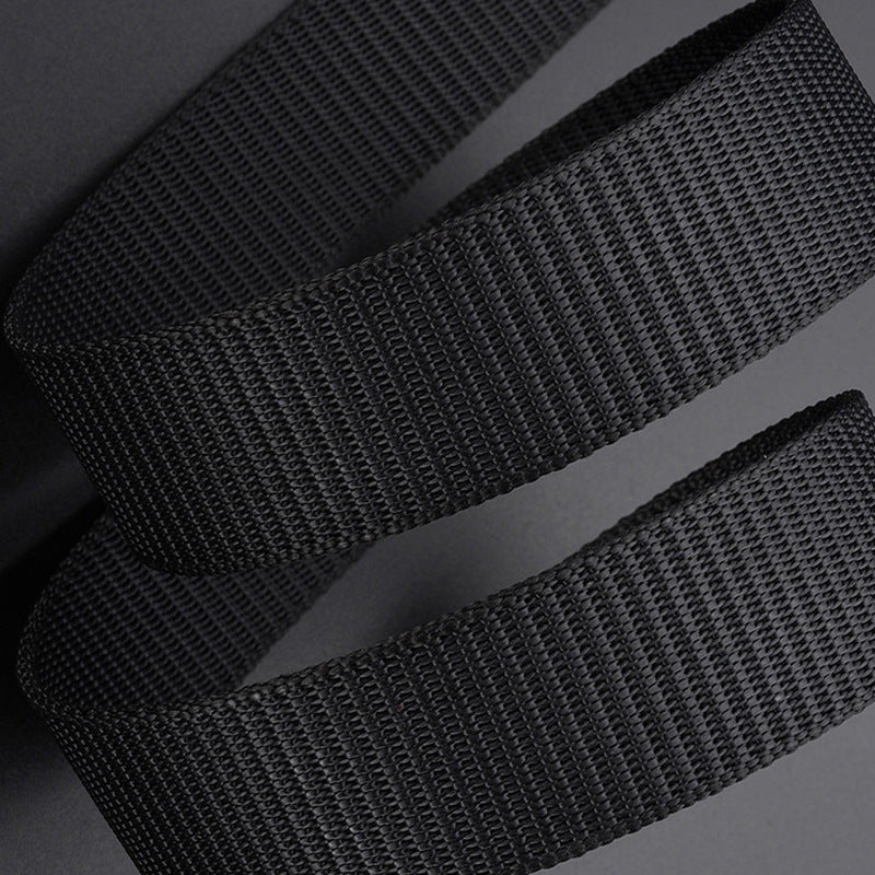 Black durable canvas belt with woven texture close-up on gray background