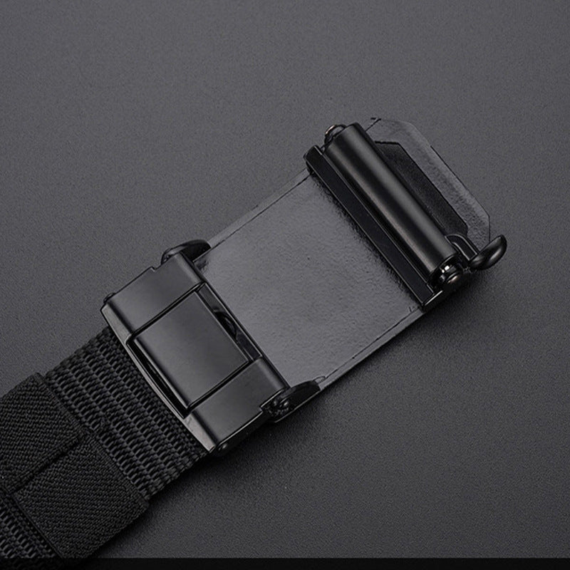 Close-up of black automatic buckle on durable canvas belt against dark background