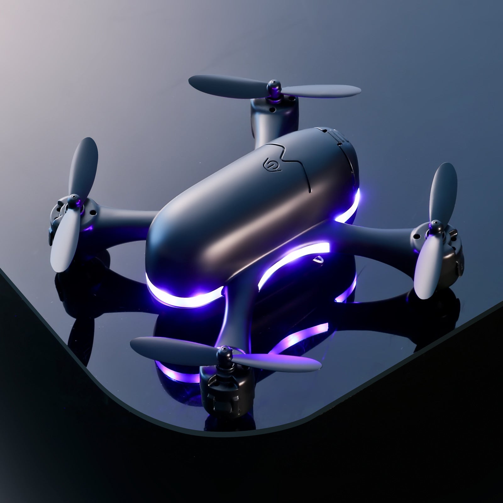 Black mini drone with quadcopter design and purple LED lights on glossy surface