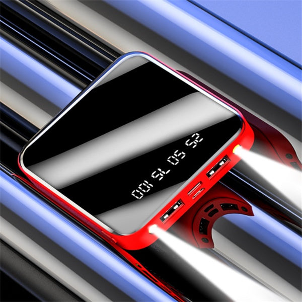 portable black and red power bank with digital battery display and dual LED flashlight on reflective surface