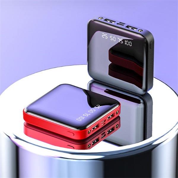 Two digital display portable power banks in black and red with multiple USB ports on a reflective surface