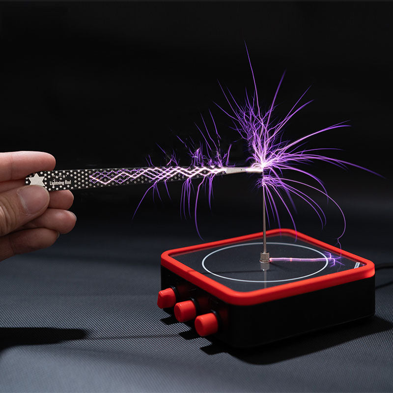 Hand holding a Lightning Rod tool creating purple electric sparks on a red and black Tesla coil device