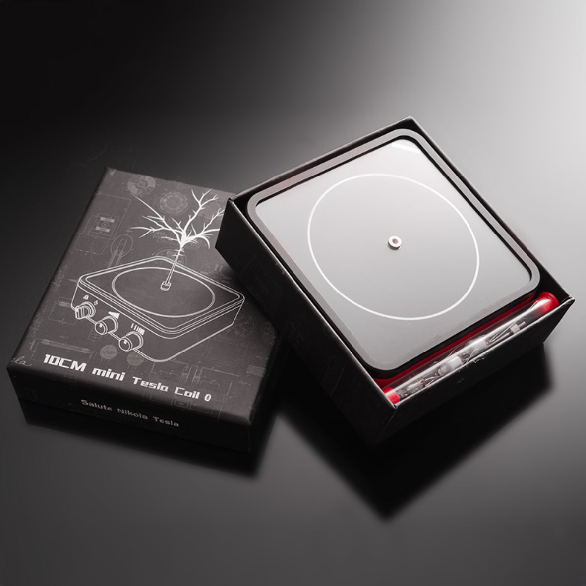 10cm mini Tesla coil physics toy in black packaging with illustration and accessories on black surface