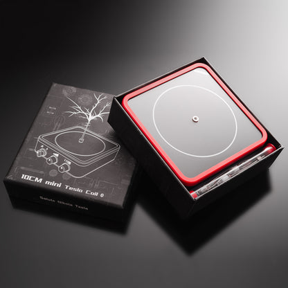 10CM mini Tesla Coil physics toy in black and red packaging with pen on black background