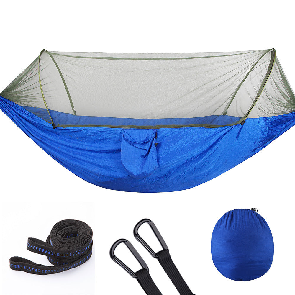 Blue camping hammock with green mosquito net, straps, carabiners, and carry bag set