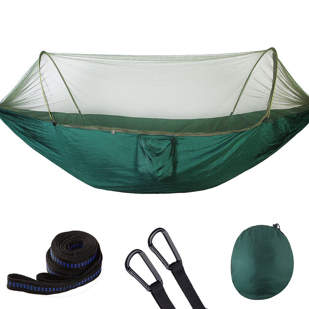 Green camping hammock with mosquito net, tree straps, carabiners, and compact carrying bag