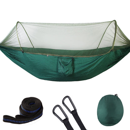 Green camping hammock with mosquito net, tree straps, carabiners, and compact carrying bag