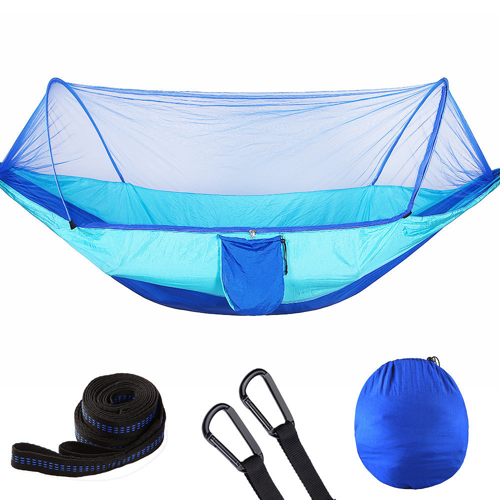 Blue camping hammock with mosquito net, straps, carabiners, and carrying pouch