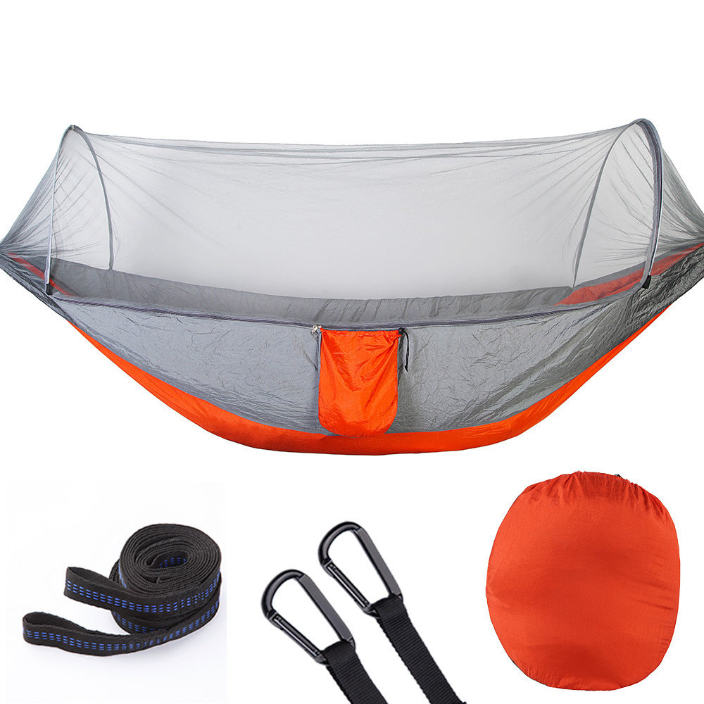 Orange and gray camping hammock with mosquito net, straps, carabiners, and storage bag