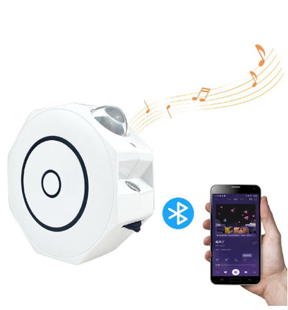 White Bluetooth speaker with star projector and music notes, connected to smartphone playing music