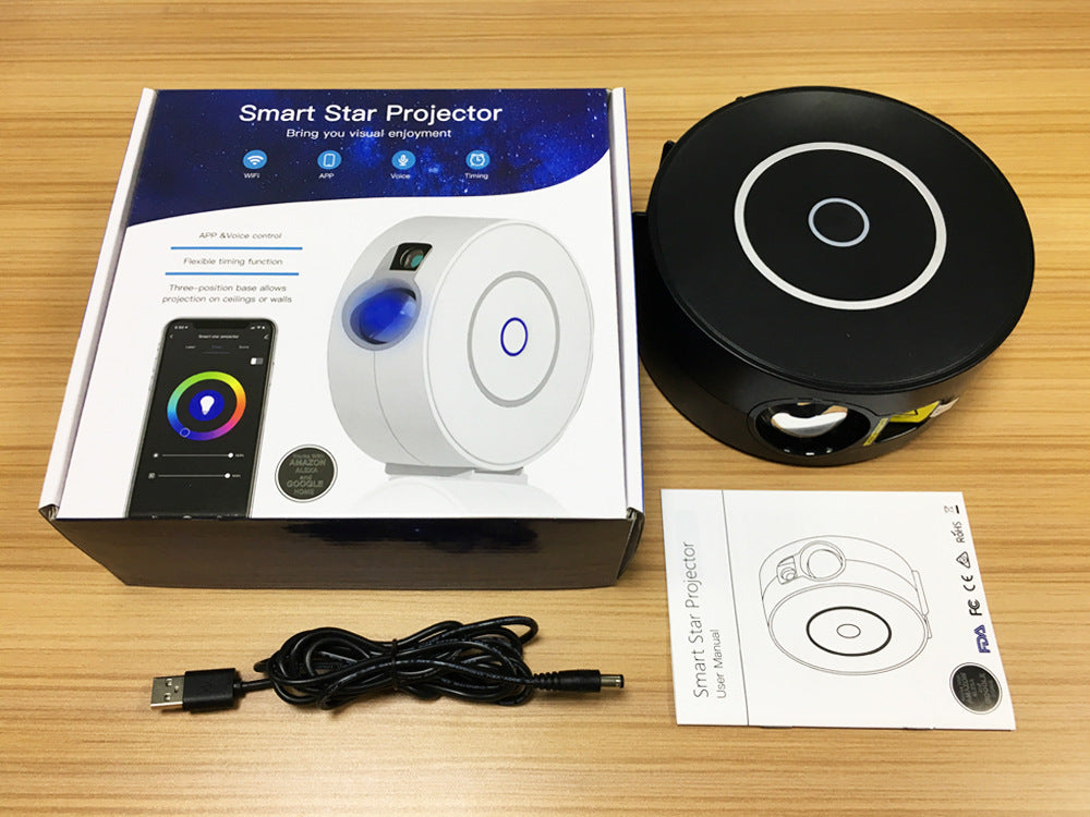 Trendoligy Smart Star Projector black unit with USB cable, user manual, and product box on wood table