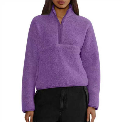 Woman wearing purple half-zip fleece sweatshirt with loose fit and lamb wool texture