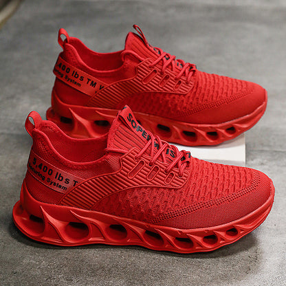 Pair of vibrant red breathable mesh men's running shoes with hollow segmented soles on gray surface