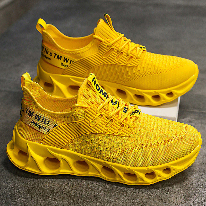Bright yellow men's breathable mesh running shoes with hollow sole design on grey surface