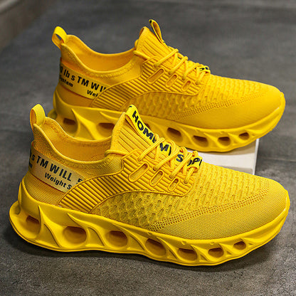 Bright yellow men's breathable mesh running shoes with hollow sole design on grey surface