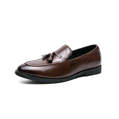Men's brown leather tassel slip-on loafer with black sole on white background