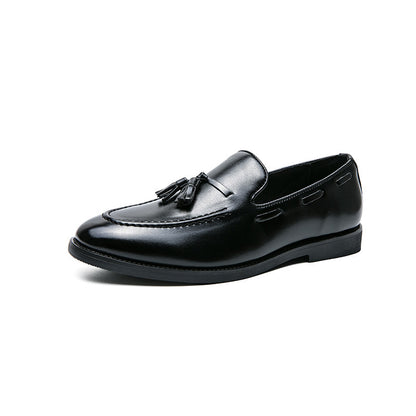 Black tassel slip-on men's dress loafer in shiny leather with stitched detailing