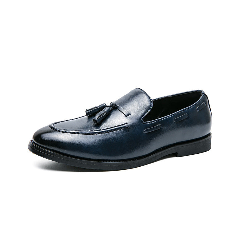 Black leather men's tassel slip-on loafer with stitched detailing and low heel on white background