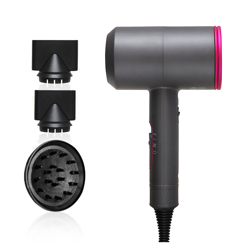 Gray salon hair dryer with pink accent and three black styling attachments on white background