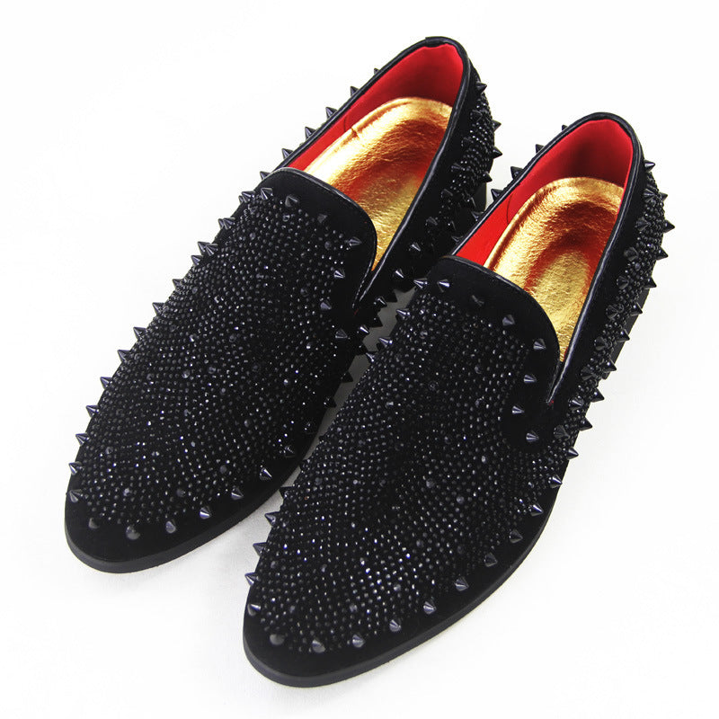 Men's black loafers with pointed toes, studded spikes, and gold-red interior lining
