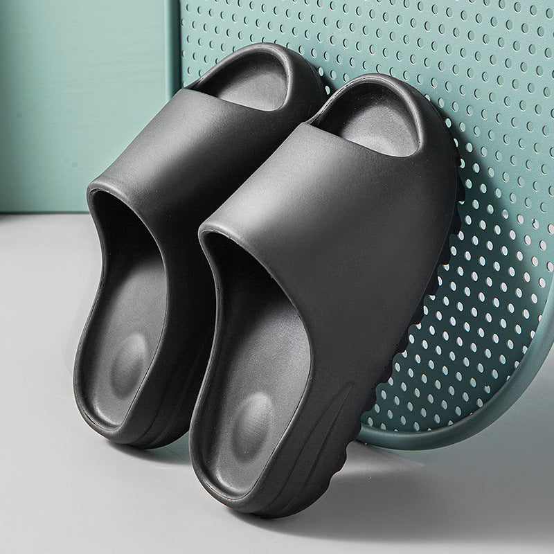 black cushioned footbed EVA slip-on sandals with thick soles on perforated teal chair