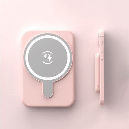 Pink magnetic wireless power bank with 5000mAh capacity next to matching pink smartphone on light pink background