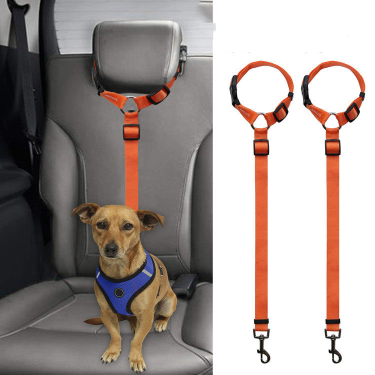 Brown dog wearing blue harness secured in car seat with orange adjustable pet safety leash restraint