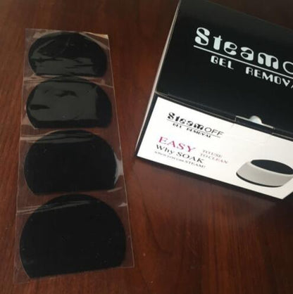 Steam Off gel nail remover machine box and four black gel remover pads on wooden surface