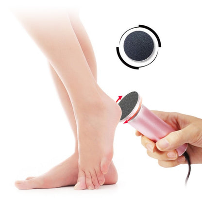 Electric callus remover held near heel of bare foot for pedicure and foot care