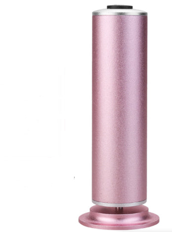 sleek metallic pink cylindrical rechargeable device with a black button on top on a matching circular base