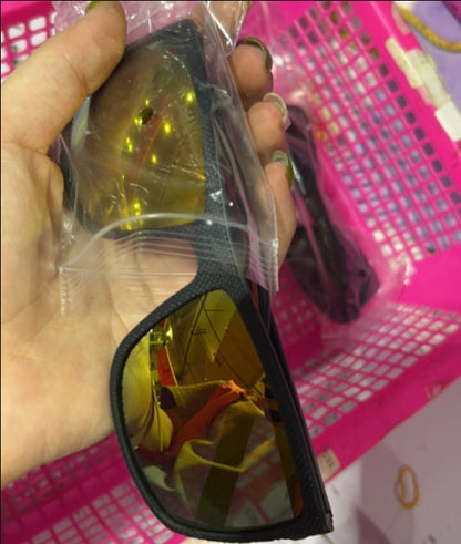 Hand holding black frame polarized cycling sunglasses with amber lenses in pink plastic basket