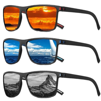 Black frame polarized cycling sunglasses reflecting sunset, ocean sailboat, and mountain scenes