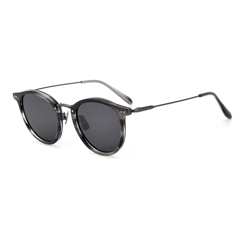 Black round-frame titanium sunglasses with gray gradient pattern and polarized UV protection lenses