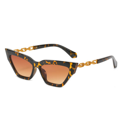 Tortoise shell cat-eye sunglasses with brown gradient lenses and gold chain temples