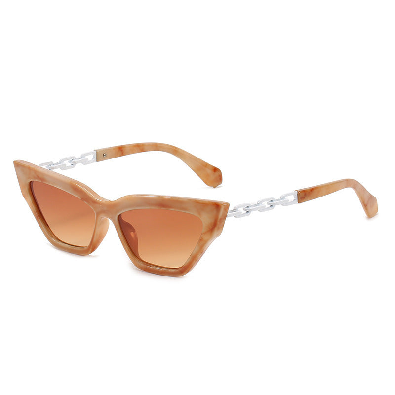 Women's cat eye sunglasses with beige marbled frames, brown gradient lenses, and silver chain temples