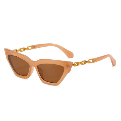 Peach cat eye sunglasses with brown lenses and gold chain link temples on white background